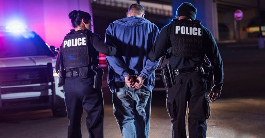 Man being arrested by officers. Contact Ford & Friedman for your criminal defense case.